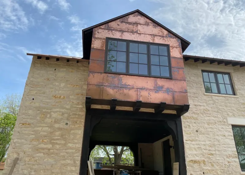 Copper metal panel facade on a stone building for Roof Repair in Phoenix